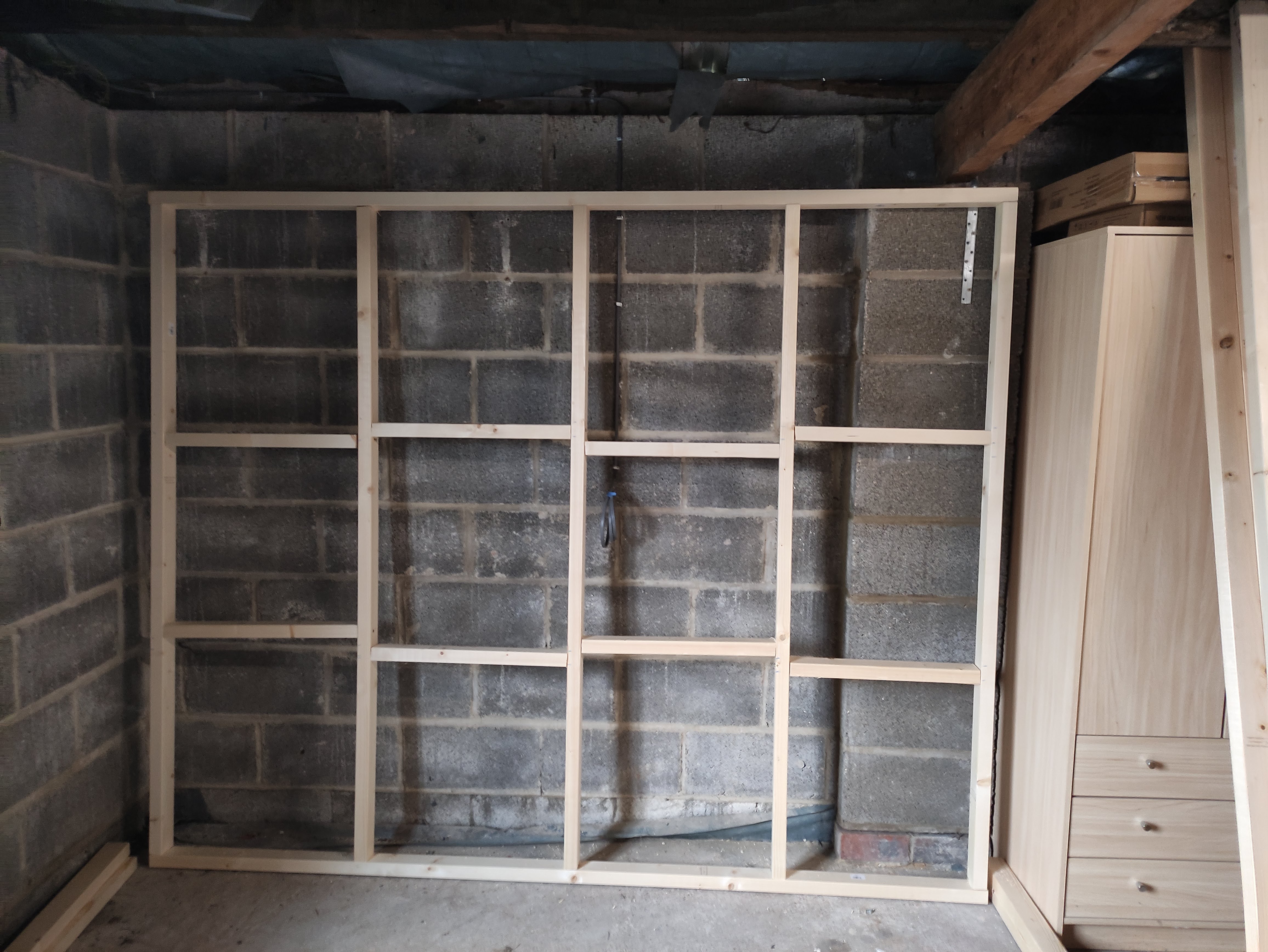 A wood frame with nogs at top and bottom